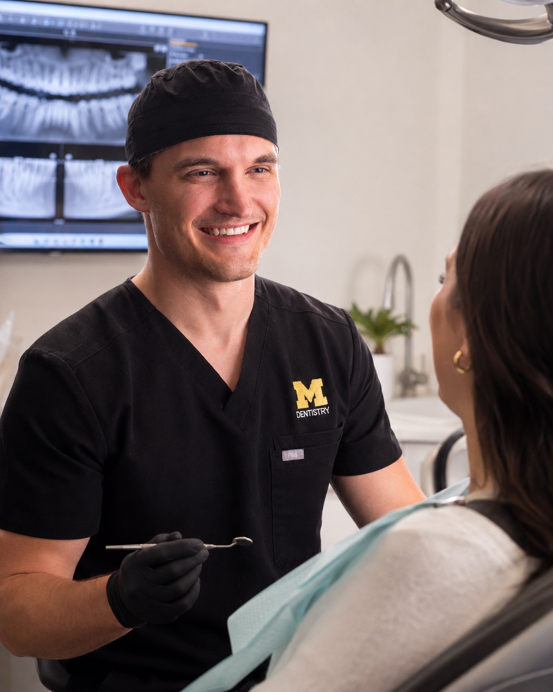 Dr. Jonathan Misch chairside with a patient at Pinckney Implants & Periodontics